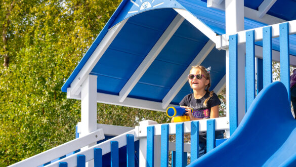 This image shows a child playing on the Rocket Launcher Playset