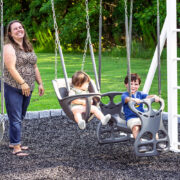 A family is enjoying a swing set