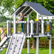 This image shows a white and black swing set from King Swings