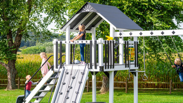 This image shows a white and black swing set from King Swings