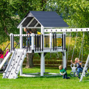 A white and black swing set with kids playing on it