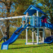 This image shows a blue and ivory swing set