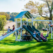 This image shows a vinyl swing set with slides swings and a ramp slide from King Swings