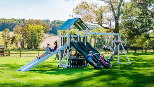 This image shows a vinyl swing set with slides swings and a ramp slide from King Swings