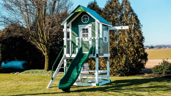 Seen is the space saving playhouse swing set, the Lodge.