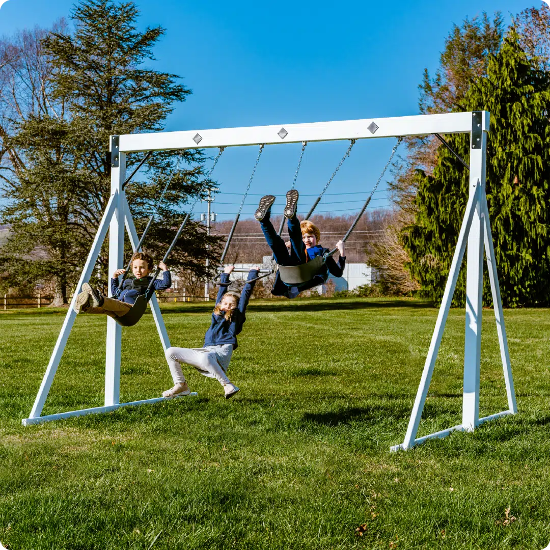 This image shows children swinging on a free-standing swing beam.