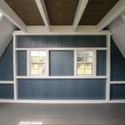 Interior view of an A frame playhouse with walls windows and open play space