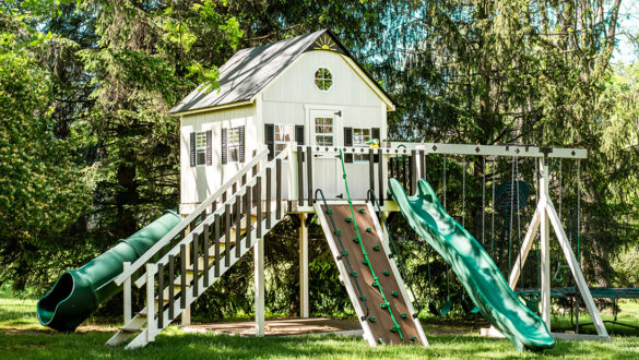 This image shows an ivory and green playhouse from King Swings