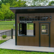 This image shows a brown and black playhouse with metal railings