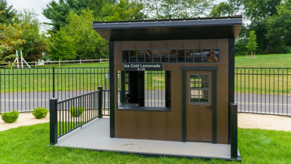 This image shows a brown and black playhouse with metal railings