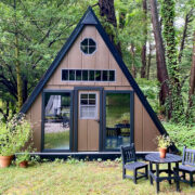 A brown playhouse in a forest