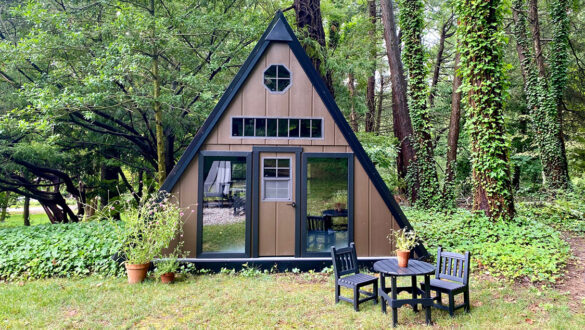 A brown playhouse in a forest