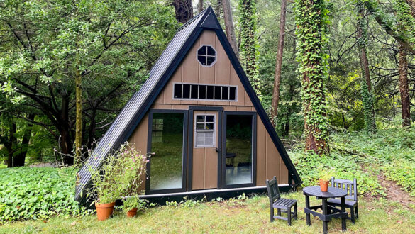 A brown playhouse in the woods