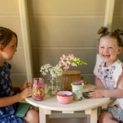 children are playing inside a playhouse from King Swings