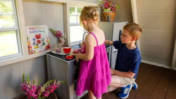 Children are playing on King Swings Play Kitchen
